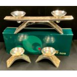 A Kurt Radke for WMF brushed steel three piece candle garniture, comprising two light candelabra,