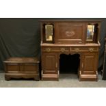 An Arts and crafts oak bureau cupboard, rectangular top above a fall front enclosing a writing