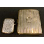 A silver cigarettes case, Birmingham 1923; a silver vesta case, 3.5oz