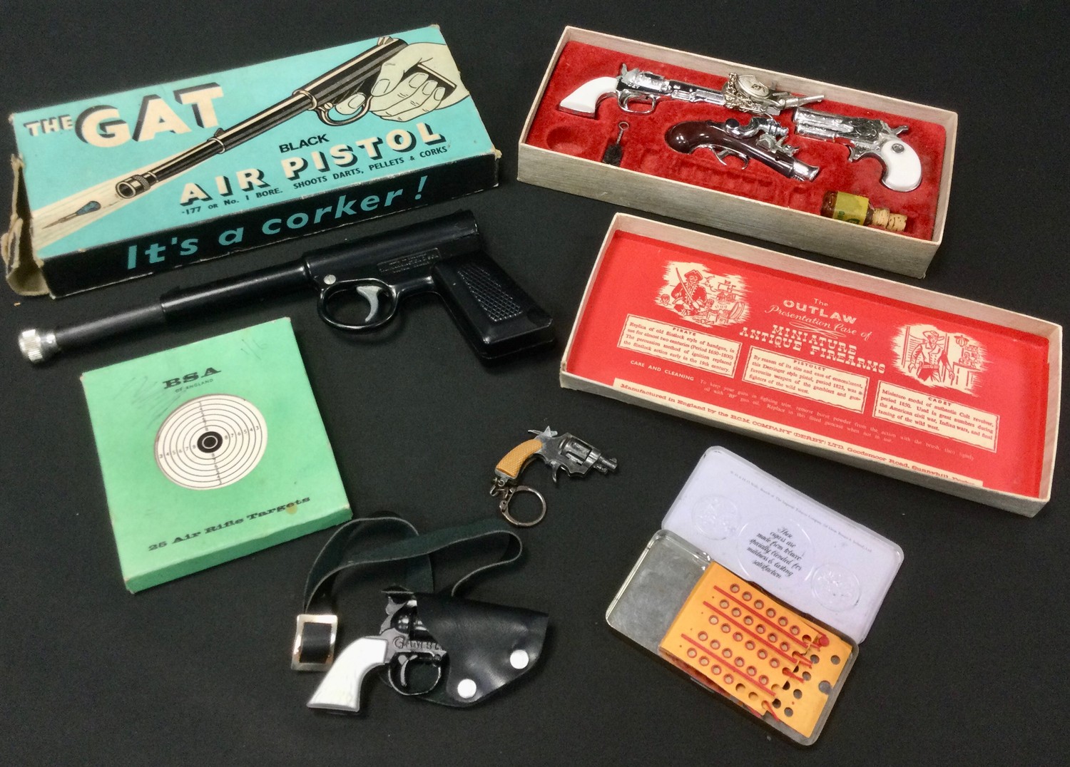 A Gat .177 calibre air pistol, boxed; The Outlaw presentation case of miniature antique firearms,