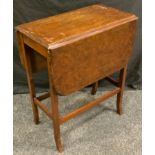 A early 20th century walnut drop leaf table, rounded rectangular swivel top, 74cm high.