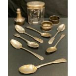 a silver pepper pot; a silver and glass dressing table jar; seven silver tea spoons; silver napkin