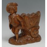 A Black Forest carving, of a gardner drawing a trolley, 14cm high, c.1900