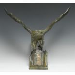 A Chinese green hardstone carving, of an eagle, the rocky base inscribed and picked out in gilt with