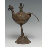 An Indian dark patinated bronze lamp, as a peacock, domed base, 20cm high