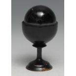 Mysticism - a 'crystal ball', turned ebonised stand, 12cm high overall