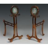 A pair of Art Nouveau period jasperware mounted copper andirons, each circular cresting set with a