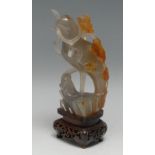 A Chinese agate carving, of a bird holding a blossoming branch, hardwood stand, 16cm high overall