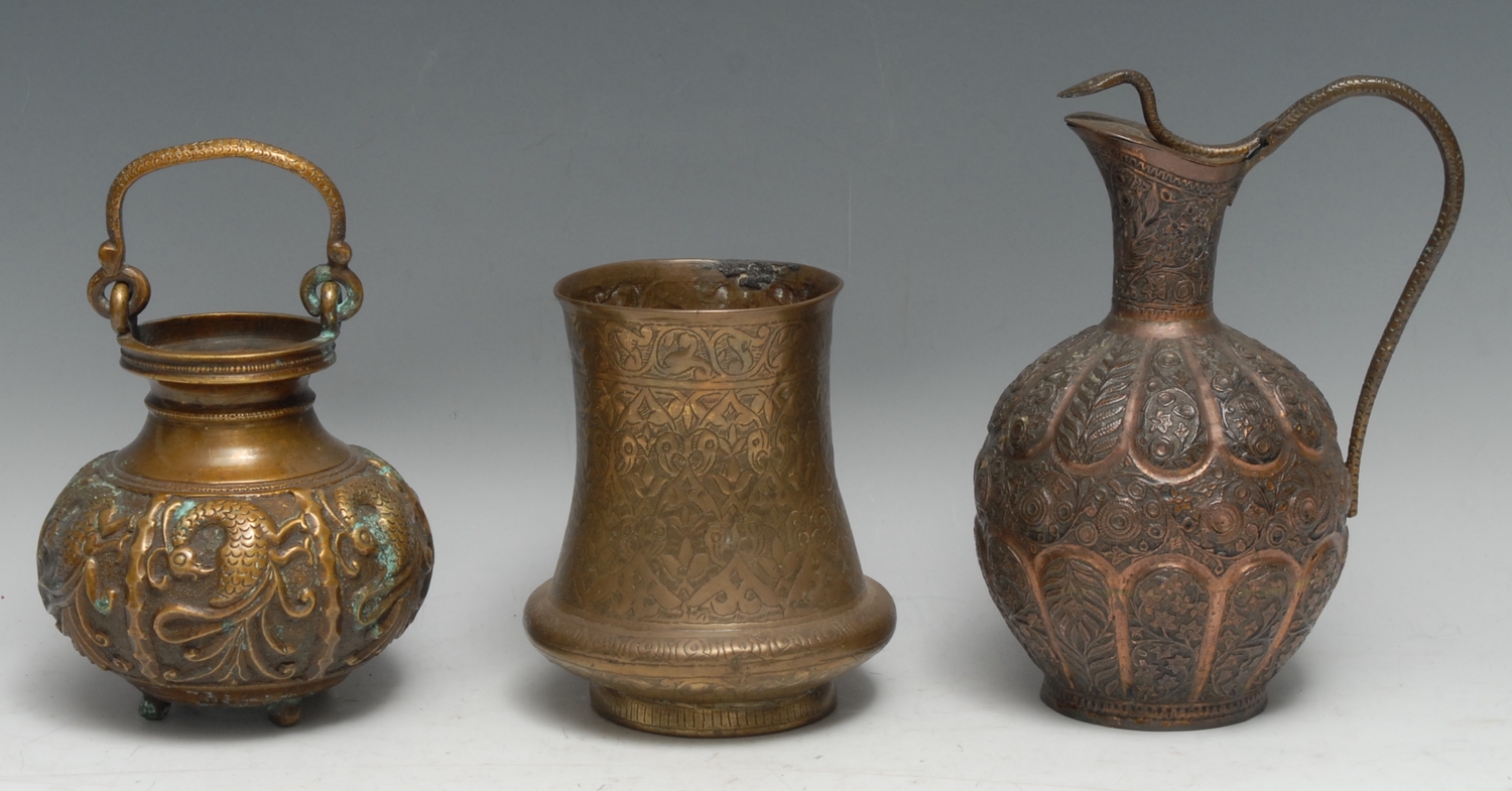 A Kashmiri copper ovoid ewer, profusely chased with dense stylised leaves, flowers and scrolling