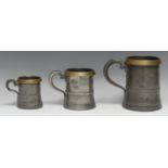 Three 19th century brass-mounted pewter tavern measures, the largest 15cm high, [3]