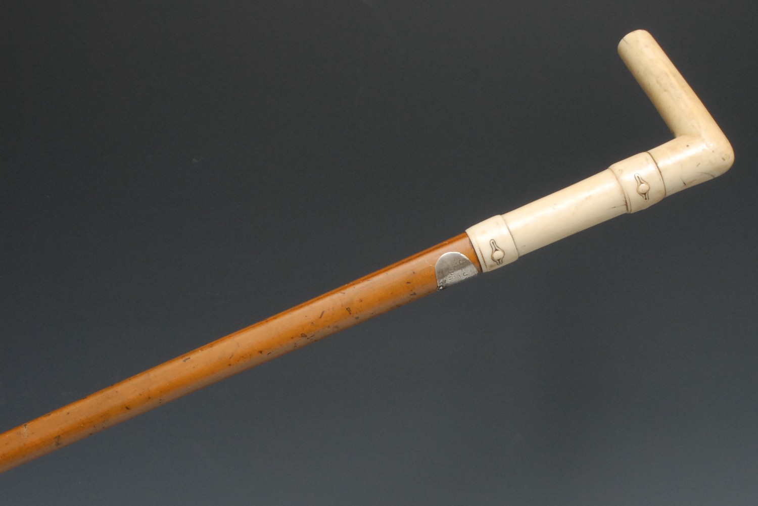 A 19th century gentleman's novelty walking stick, the L-shaped ivory handle carved with faux