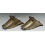 A pair of South American brass Conquistador stirrups, cast and chased with flowers, stiff leaves and