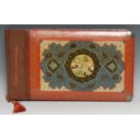 A Persian papier-mâché and marquetry rounded rectangular photograph album, the front painted with