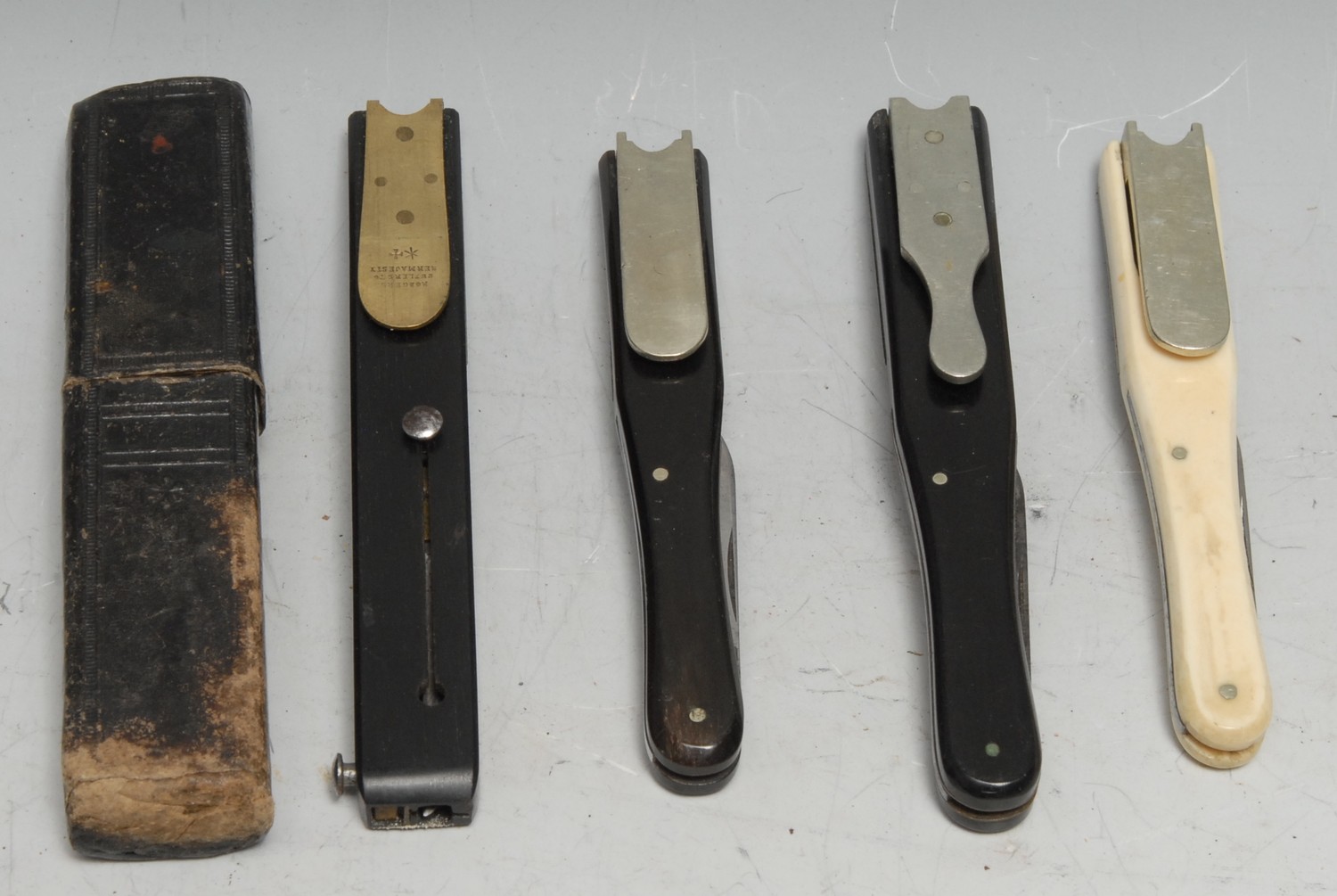 A 19th century ebony quill cutter, by Rodgers, Sheffield, tooled slip case; others, similar (4)