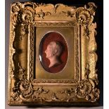 A 19th century wax portrait, of a gentleman, in profile facing to dexter, 7cm x 5cm, inscribed to