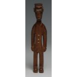 Tribal Art - an African Colonial figure, carved as a uniformed official in European dress, his