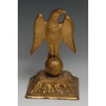 A Baroque giltwood carving, of an eagle atop an orb, spreading square base carved with a border of