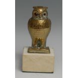 A brass novelty deskweight, as an owl perched upon an open book, marble base, 10.5cm high