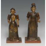 A pair of Indian softwood figures, of women in traditional dress, 21.5cm and 19cm high, probably