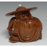 A Chinese hardwood carving, of Hotai, sleeping beneath a broad-brimmed hat, 16cm high, c. 1900