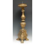 A substantial Baroque giltwood and gesso pricket candlestick, lobed compressed campana snonce,