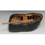 A scratch-built model of a coracle boat, 23.5cm long