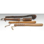 An early 20th century turned cosh, 42.5cm long; a police truncheon, turned grip, 40cm long; another,