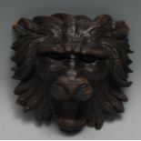 A 19th century oak wall boss, carved as a lion mask, 15cm wide