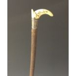 A rare Queen Anne silver-mounted ivory and piqué riding crop, tau-shaped grip typically inlaid