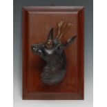 A Black Forest wall plaque, carved as the head of a deer, facing to dexter, rectangular mahogany