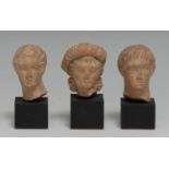 Antiquities - an Greek terracotta statuette fragment, head of a young man, 3.5cm high, probably