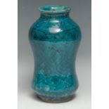 A Middle Eastern albarello, the turquoise glaze decorated in black with stylised lotus, 21cm high