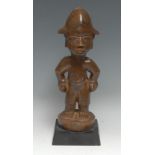 Tribal Art - a Yoruba figure, he stands, with each hand full, 33cm high, Nigeria, ebonised