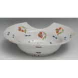 A 19th century French faience barber's blood-letting bowl, painted with scattered sprigs in