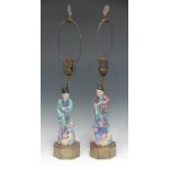 A pair of Chinese porcelain figural table lamps, the traditional man and woman wearing flowing robes
