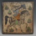 A Qajar tile, painted with a Persian falconer on horseback, 24.5cm x 24cm, 19th century