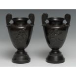 A pair of 19th century brown patinated bronze urns, after Ancient Greek volute kraters, each cast