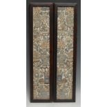 A pair of 19th century Chinese silk sleeve panels, densely embroidered with vases of flowers,