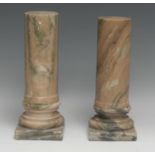 A pair of marble library desk columns, turned socles, square bases, 25.5cm high