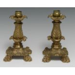 A pair of 19th century gilt-patinated bronze candlesticks, cast throughout with acanthus, bold