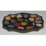 A pietra dura shaped serpentine desk weight, inlaid with pebble reserves of amethyst quartz, lapis