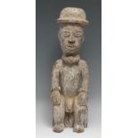 Tribal Art - an Igbo figure, carved as a seated man, white pigment, 40cm high, Nigeria