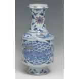 A Chinese vase, decorated in tones of blue and manganese with dragons and flowering stems, 22cm