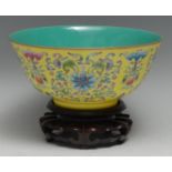 A Chinese circular bowl, brightly painted in polychrome enamels with lotus scrolls and precious