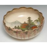 A Japanese Satsuma shaped circular bowl, the interior typically decorated with traditional