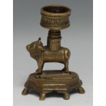 An Indian bronze lamp or rosewater droppers, cast as a cow, the circular 'sconce' screw-threaded and