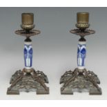 A pair of 19th century porcelain mounted bronzed metal candlesticks, half-fluted cylindrical