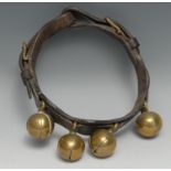 A 19th century leather animal collar, with four crotal bells, 20cm diam