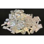 A collection of Chinese mother of pearl gaming tokens, various shapes and sizes, some monogrammed,