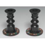 A pair of pietra dura candlesticks, turned pillars, circular bases inlaid with chevron bands of